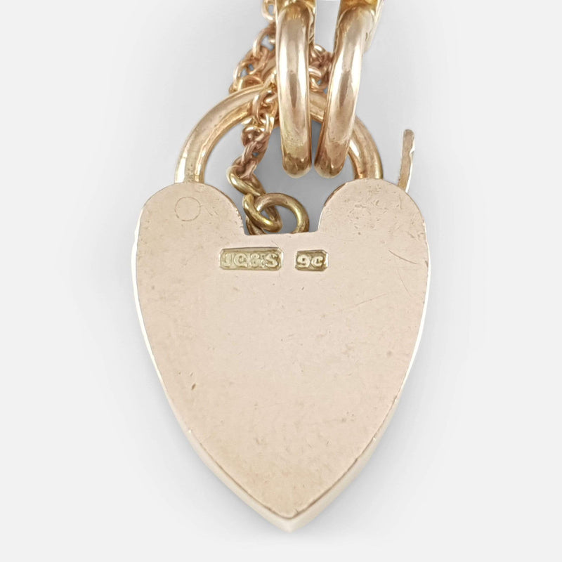 the back of the heart padlock with makers marks in focus