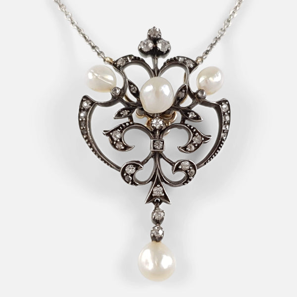 the pearl and diamond pendant in focus