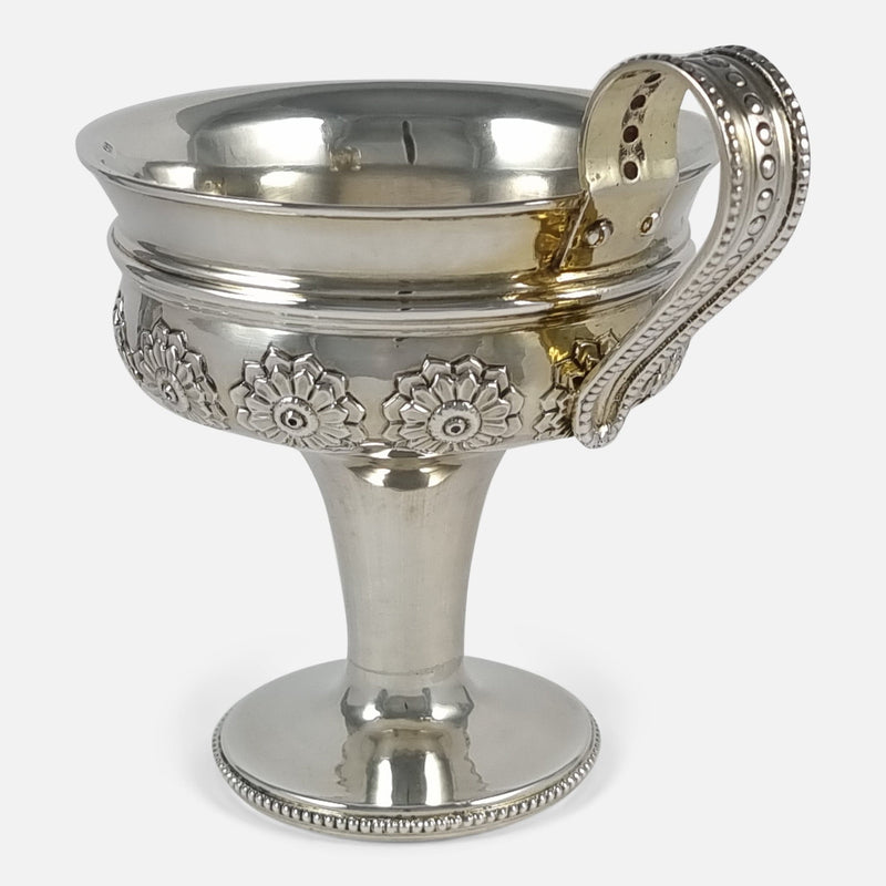 the cup viewed with handle to the forefront and angled slighly towards the right side