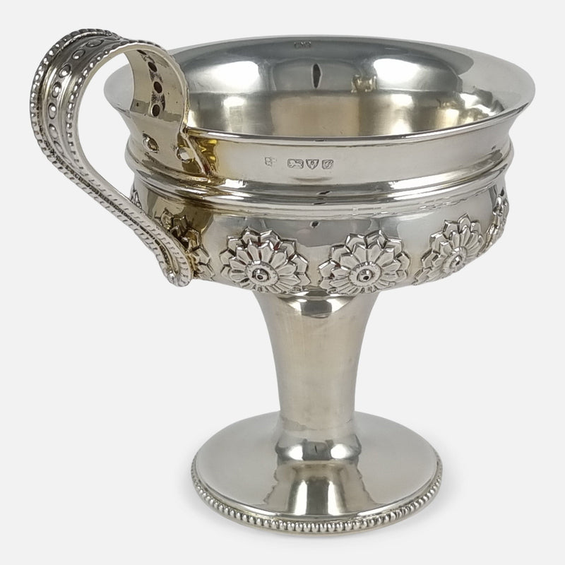 the cup viewed with handle to the forefront and angled slighly towards the left side