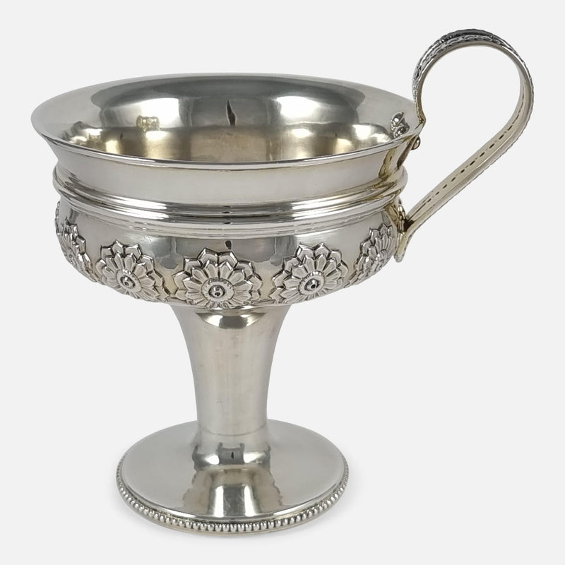 the cup viewed side on with handle pointing to the right side