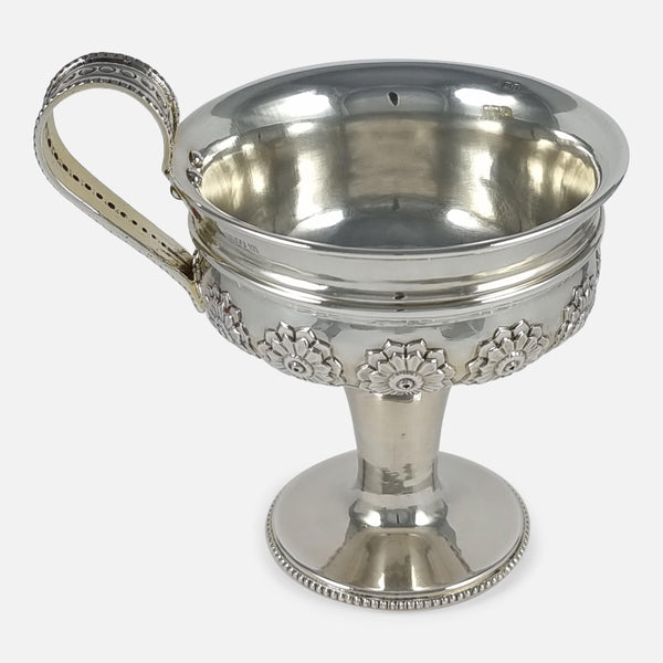 the cup viewed side on with handle pointing to the left side