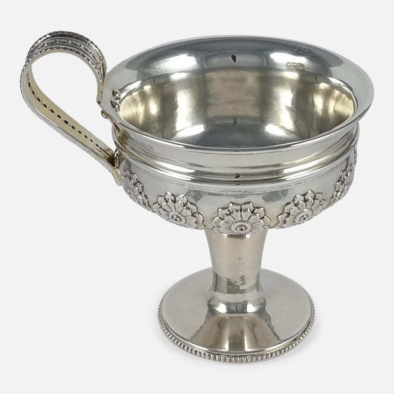 the cup viewed side on with handle pointing to the left side