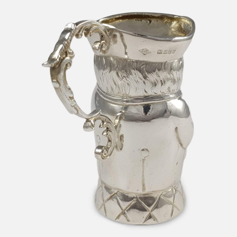 the jug facing away with handle in focus to the forefront