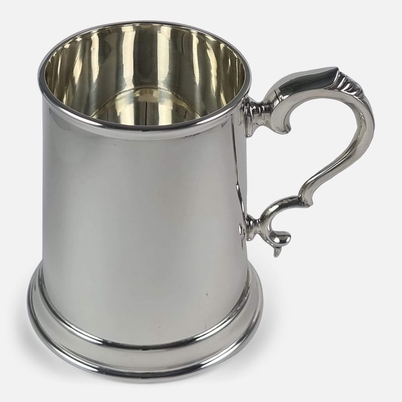 the sterling silver mug viewed with handle facing side on towards the right