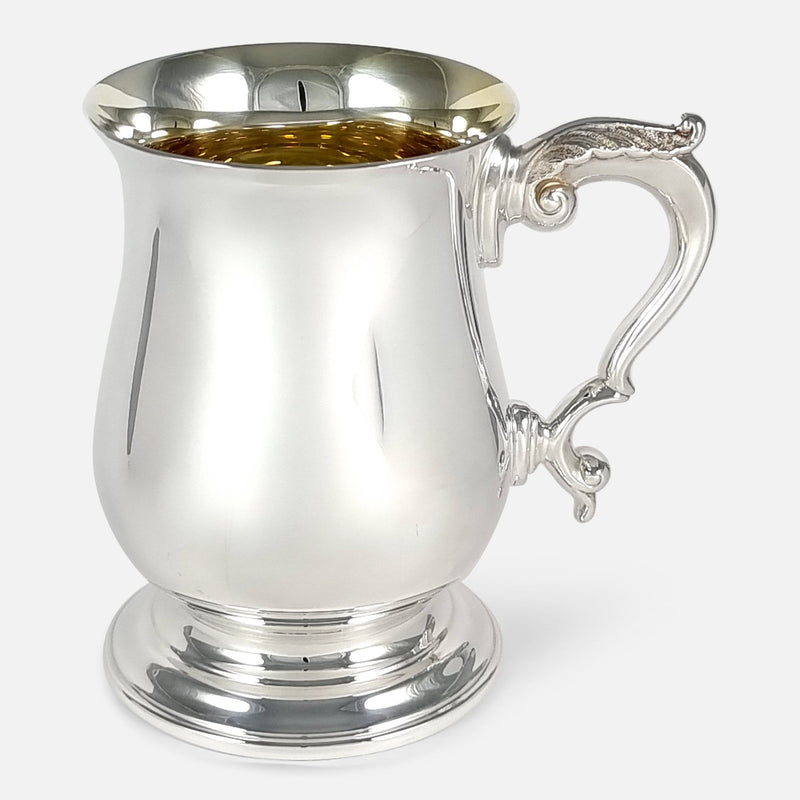 the sterling silver mug viewed side on with handle pointing right
