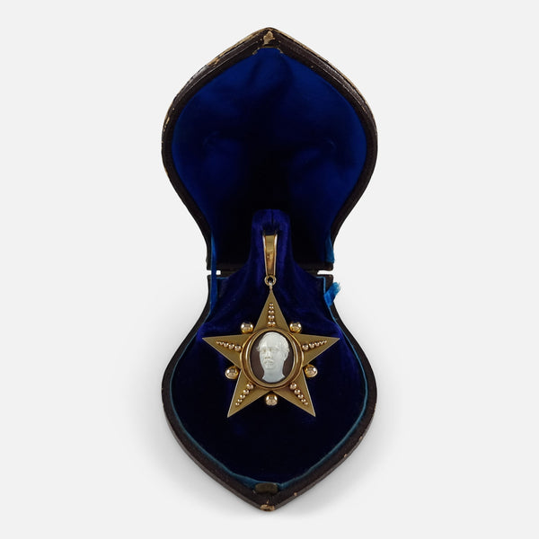 the gold pendant viewed in its case