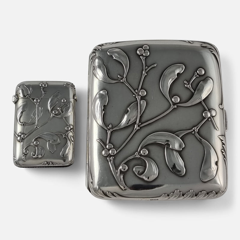 the Art Nouveau silver cigarette case and vesta case side by side