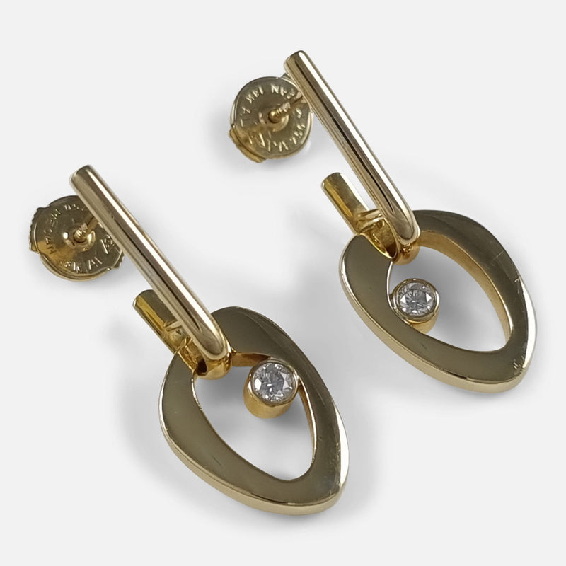 the pair of 18 carat gold earrings viewed diagonally