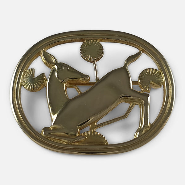 A Georg Jensen 18 carat yellow gold kneeling fawn brooch viewed from the front