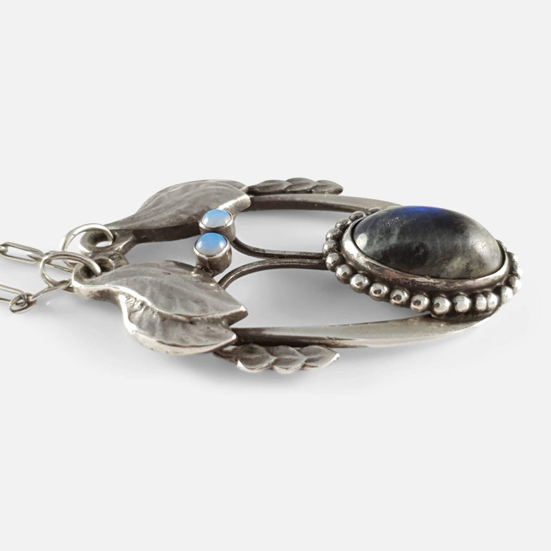 the silver pendant viewed from the left side on