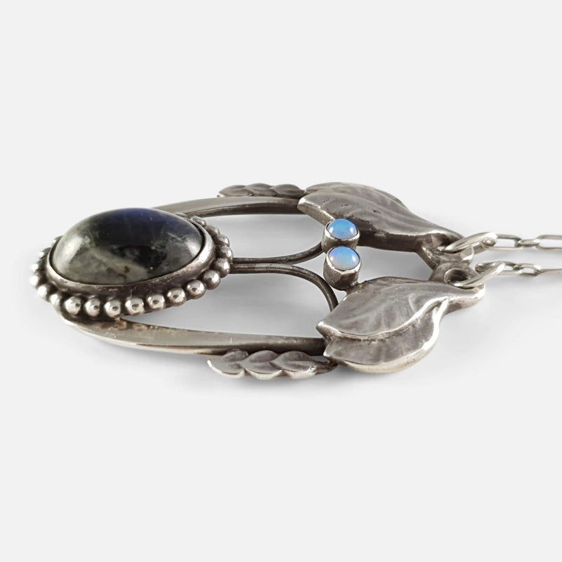 the silver pendant viewed from the right side on