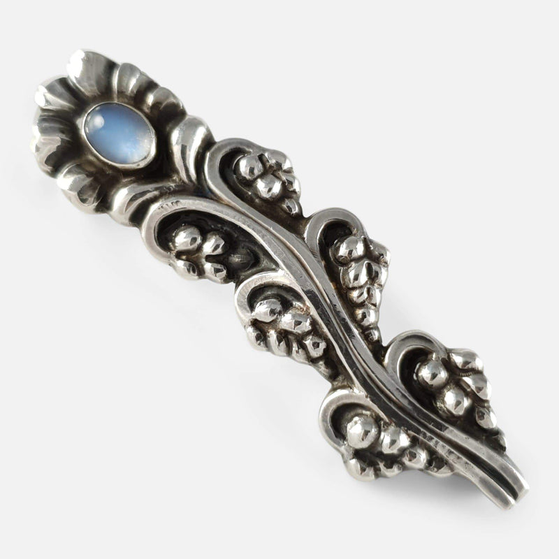 the silver brooch viewed diagonally