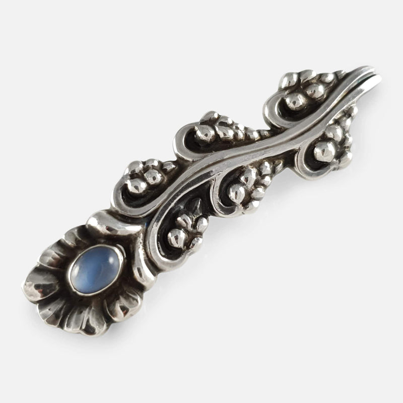 the brooch viewed diagonally with moonstone cabochon to forefront