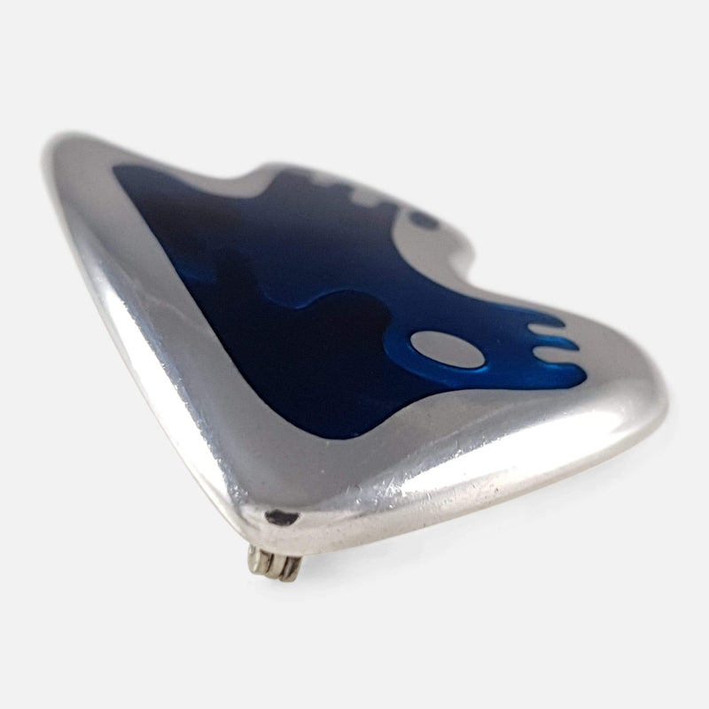 the silver brooch viewed from the right side on