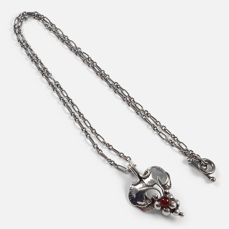 the silver pendant and chain viewed diagonally