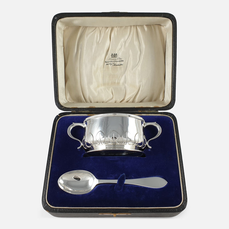 the sterling silver two handled porringer and spoon viewed in the case