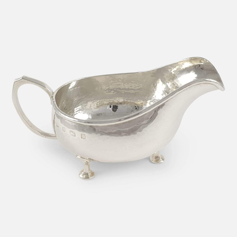 a side on view of the silver sauce boat