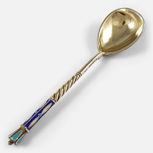 the silver spoon lying diagonally with handle to forefront