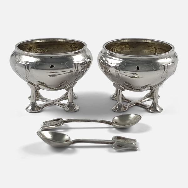 the pair of salt cellars with spoons laid out in front