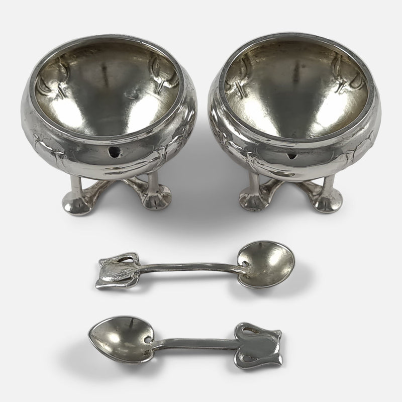 a birds eye view of the salt cellars and spoons laid out separately 