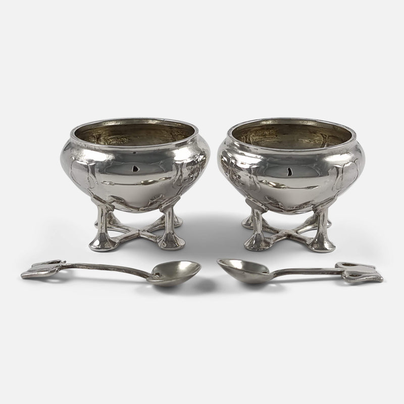a view of the pair of salt cellars with spoons laid out in front