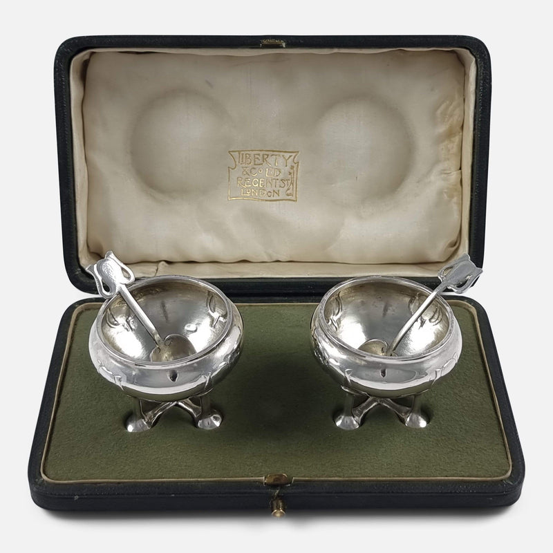 The pair of Art Nouveau Liberty & Co sterling silver salt cellars viewed in their case