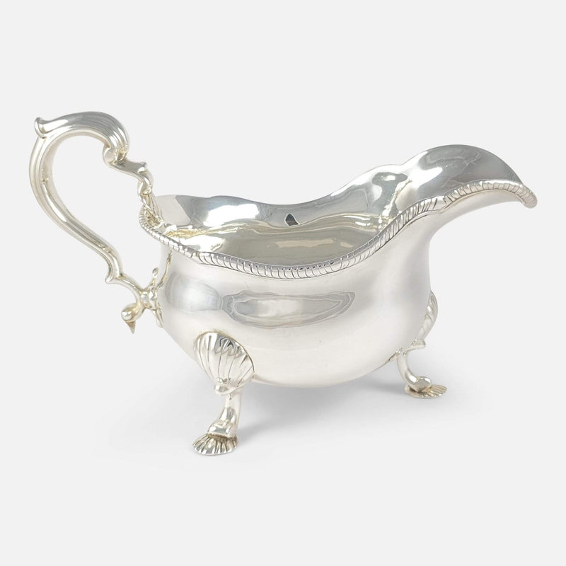 one of the antique sterling silver sauce boats viewed side on