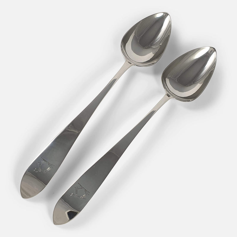 the pair of silver serving spoons viewed diagonally