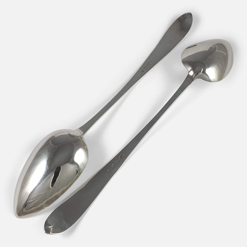the backs of the pair of spoons facing in opposite directions