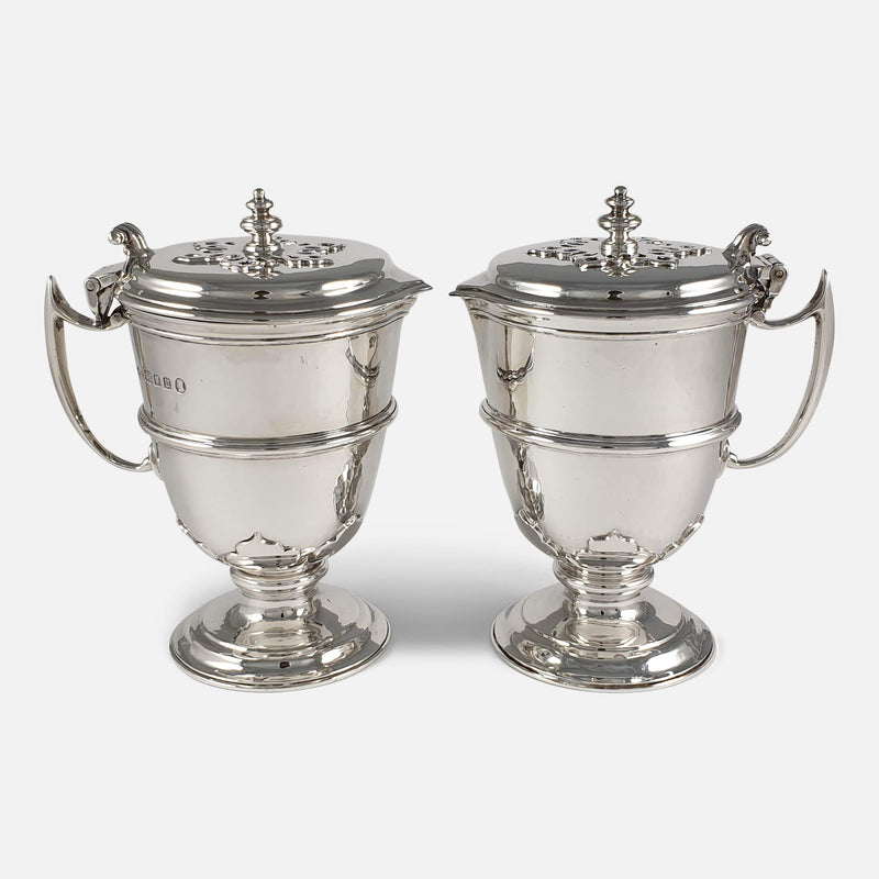 both silver jugs turned side on facing each other