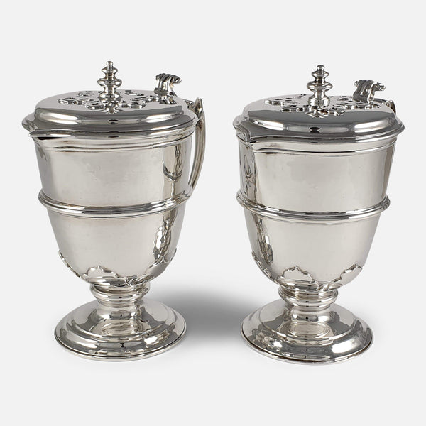 the silver ewers viewed from an angle both facing in the same direction