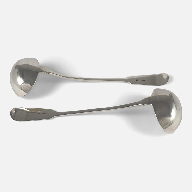 the ladles viewed horizontally face down and going in opposite directions