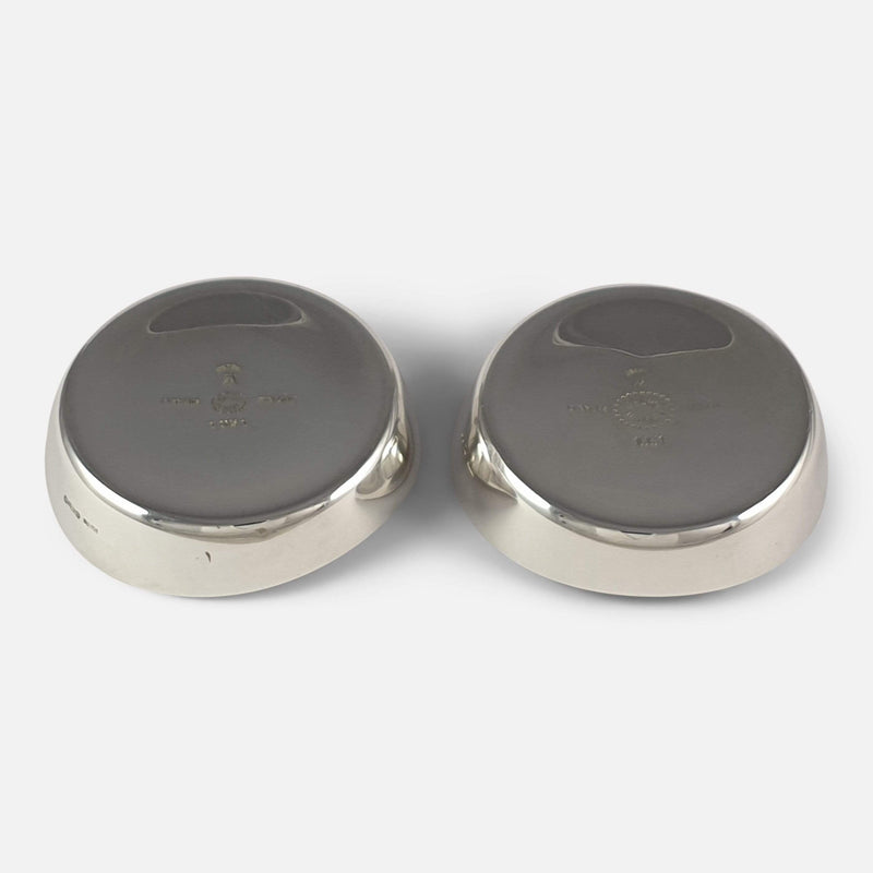 the pair of silver candlestick holders viewed upside down