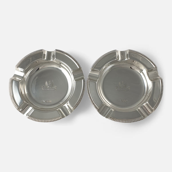 the pair of sterling silver crested ashtrays viewed side by side