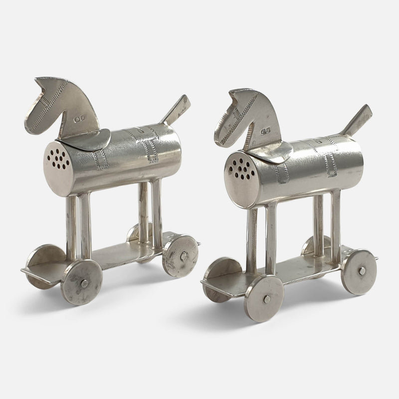 the sterling silver 'Hobby Horse' pepper pots viewed at an angle