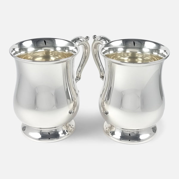 the pair of Elizabeth II sterling silver mugs viewed side by side