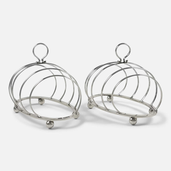 the pair of antique sterling silver Toast Racks viewed at an angle