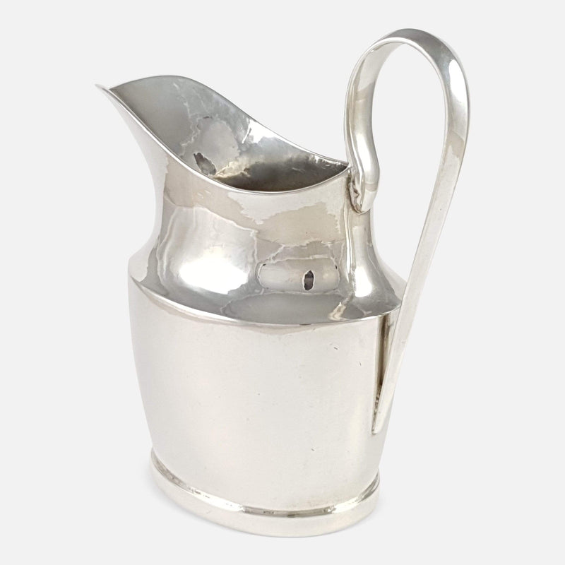 The cream Jug viewed from the back to include the handle to the forefront