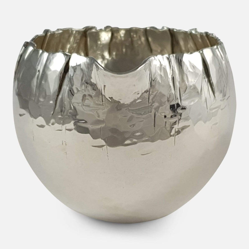 the silver creamer viewed from the front