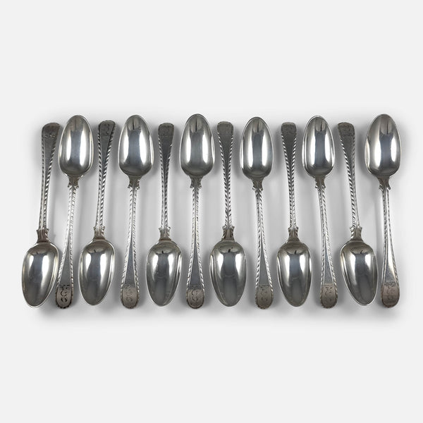 the set of 12 George III silver feather edge teaspoons viewed from above