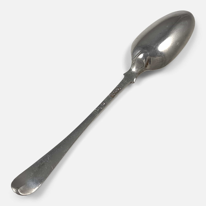 one of the teaspoons viewed face down diagonally with the bowl facing towards the upper right corner