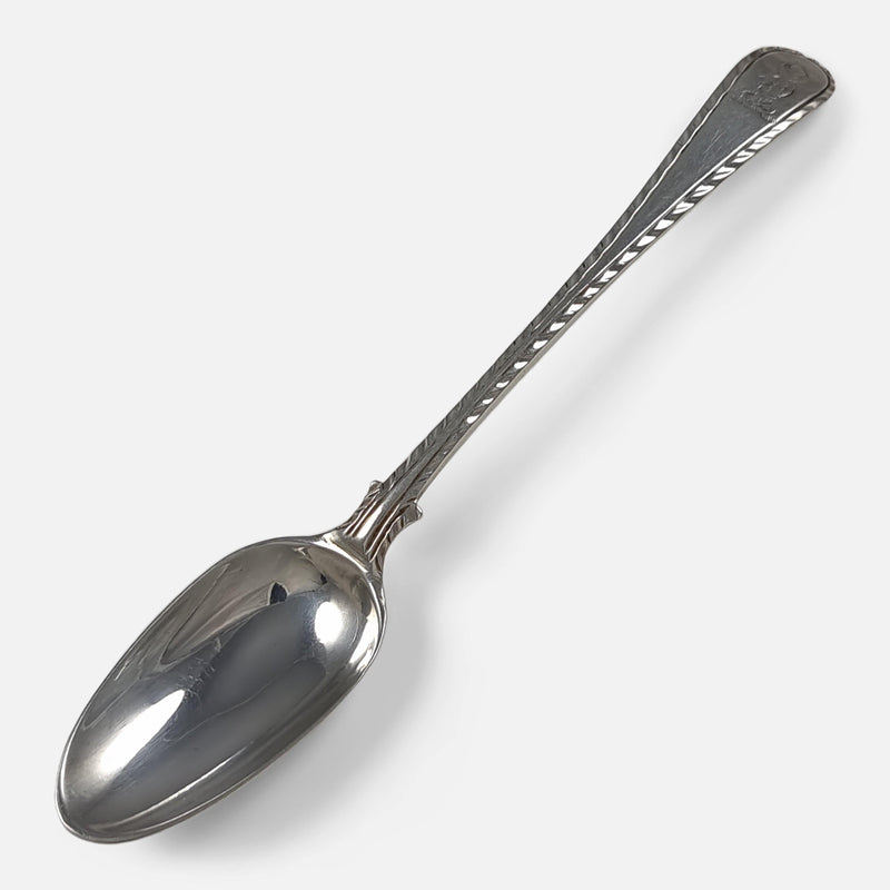 one of the teaspoons viewed diagonally with the bowl facing towards the lower left corner