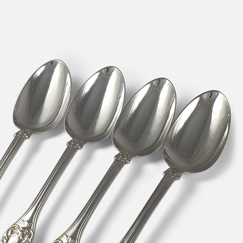 focused on 4 of the bowls of the silver spoons