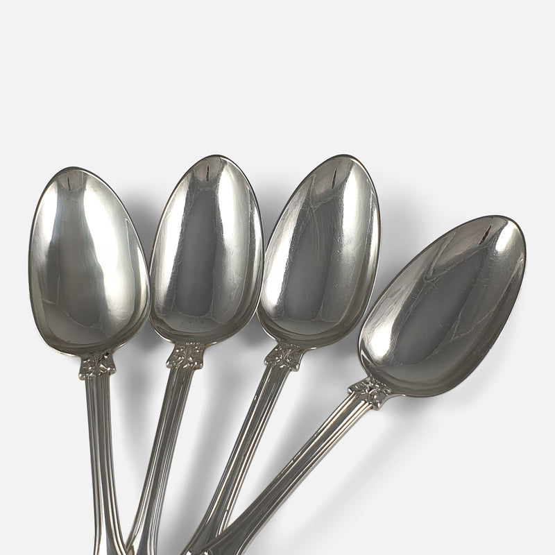 focused on 4 of the bowls of the silver spoons