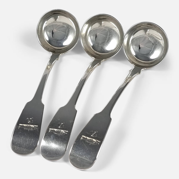 the three antique Scottish silver toddy ladles viewed at an angle