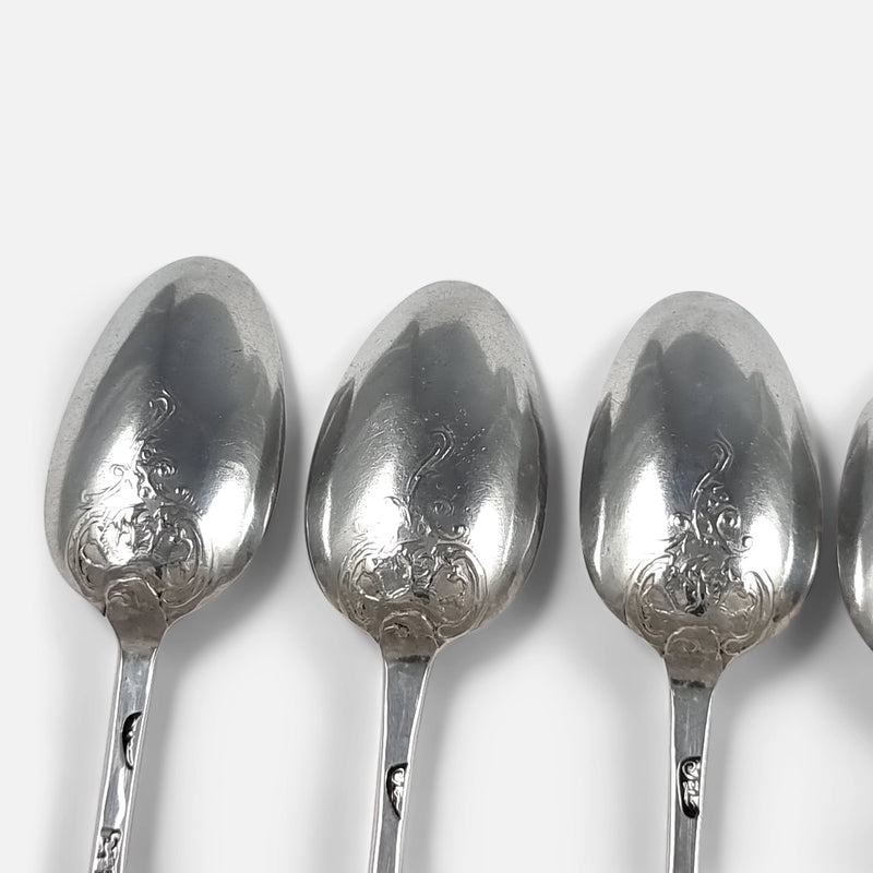 the fancy back decoration to the backs of three of the spoons