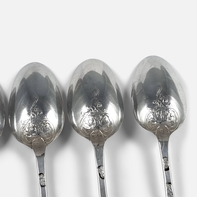 the fancy back decoration to the backs of three of the spoons