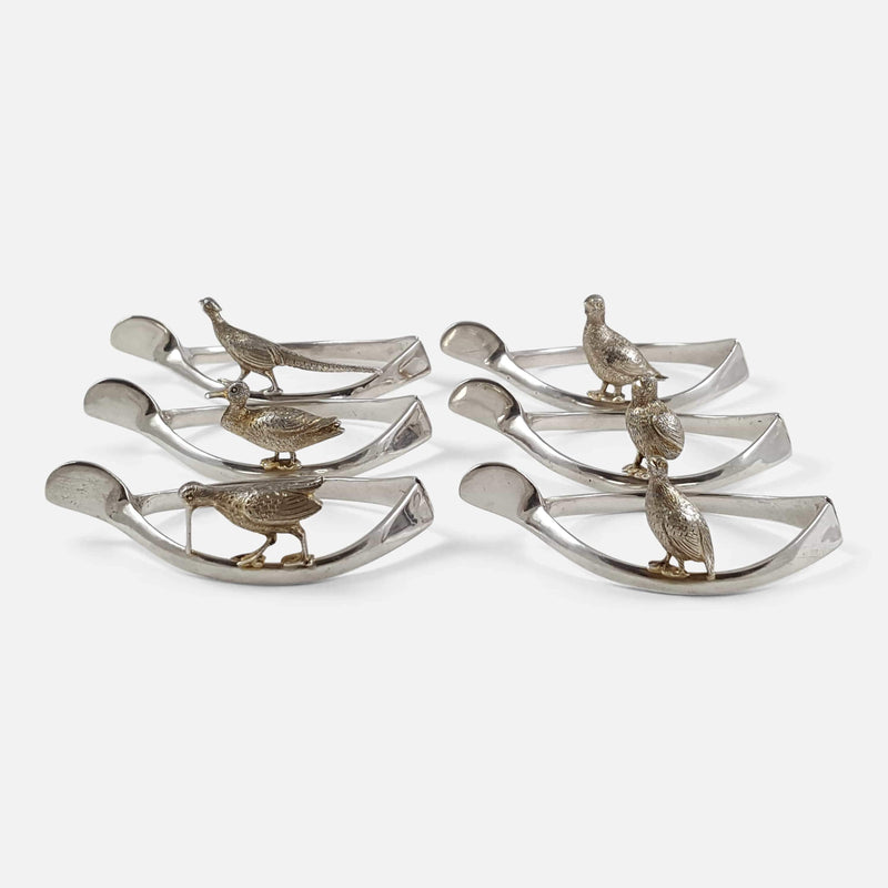 the set of 6 silver wishbone and game bird napkin rings viewed from the right side