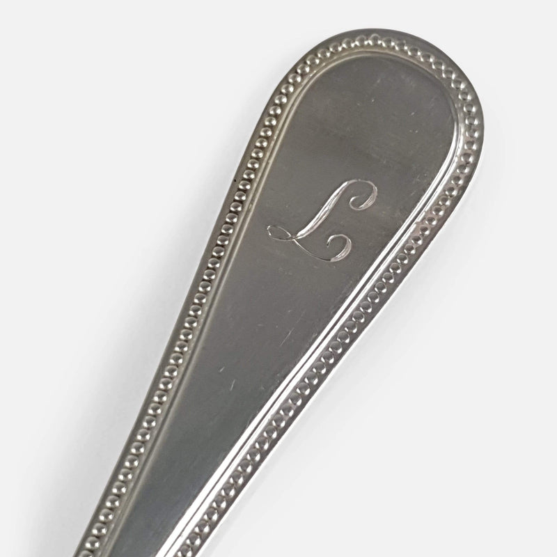 the engraved initial to one of the handles